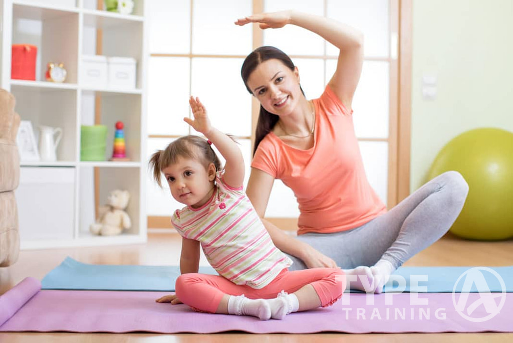 young girl working out with her mom