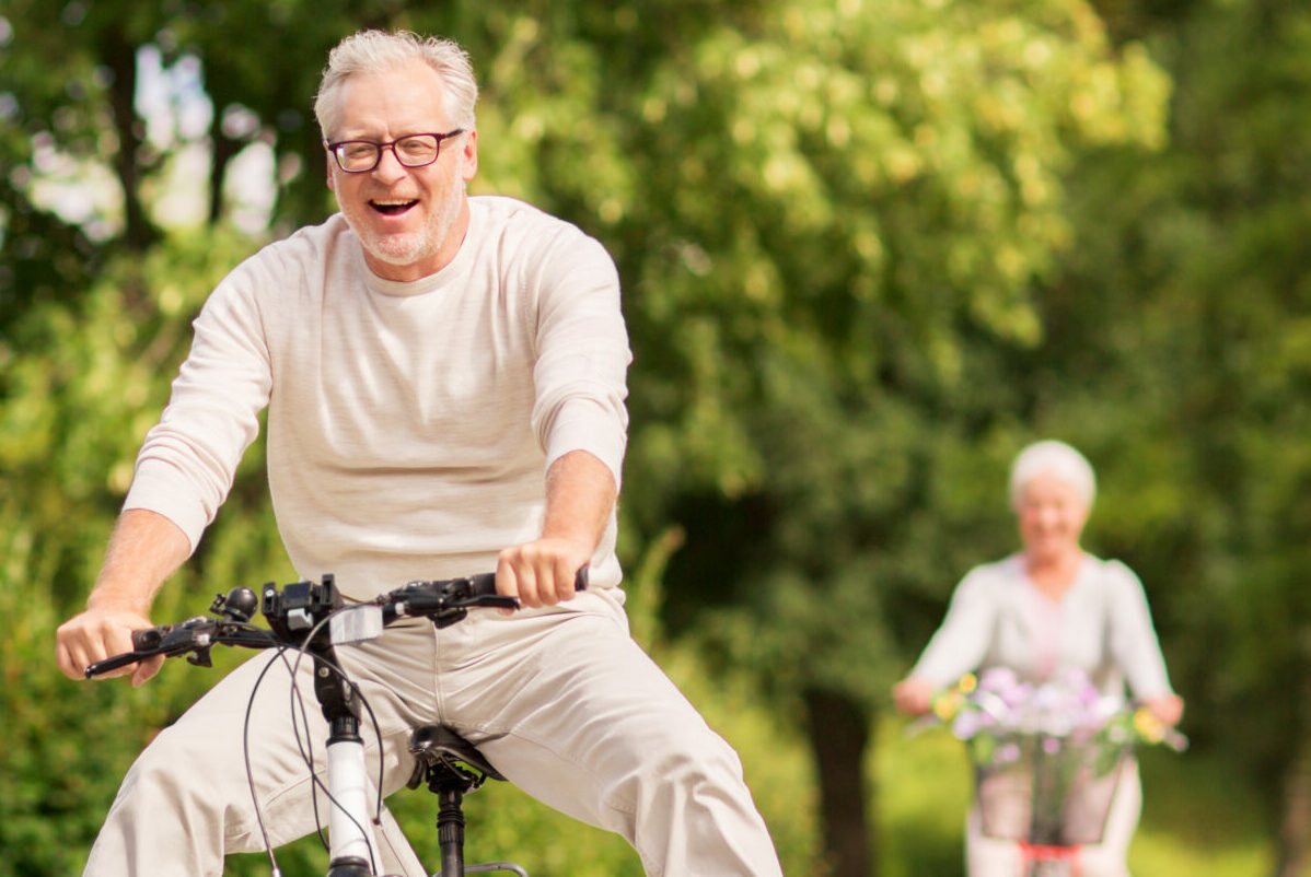 a man and woman riding bikes
