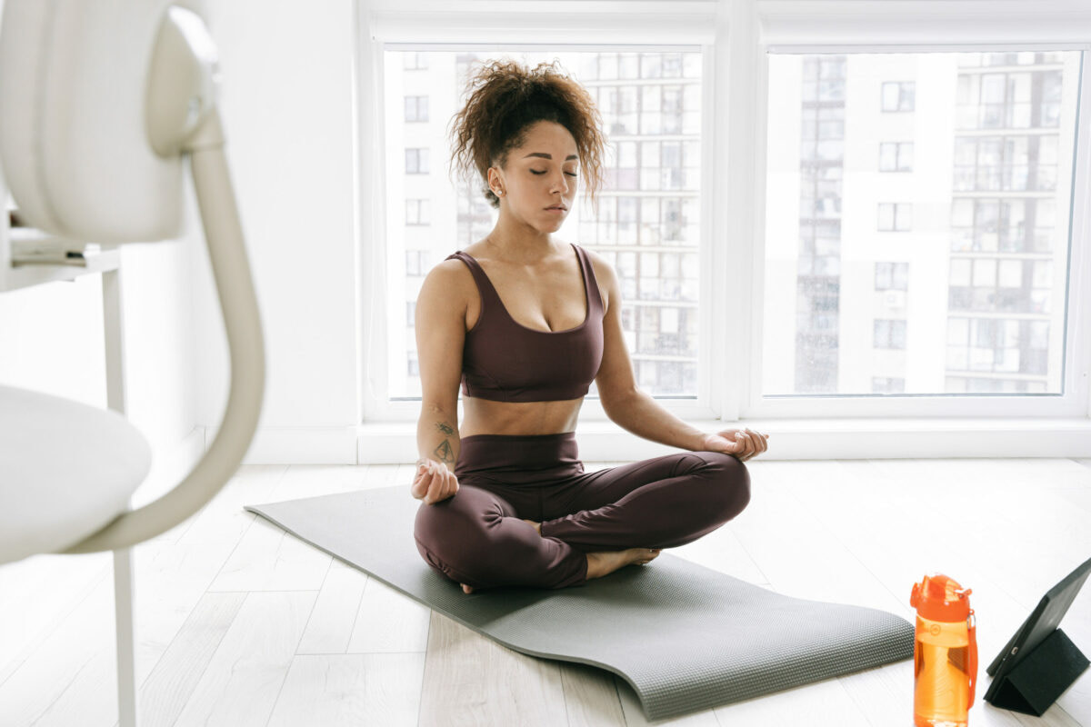 Long-Term Health and Lifestyle Benefits from yoga, female in her home practicing yoga breathing