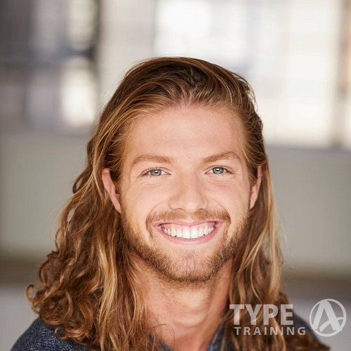 a man with long hair and beard smiling