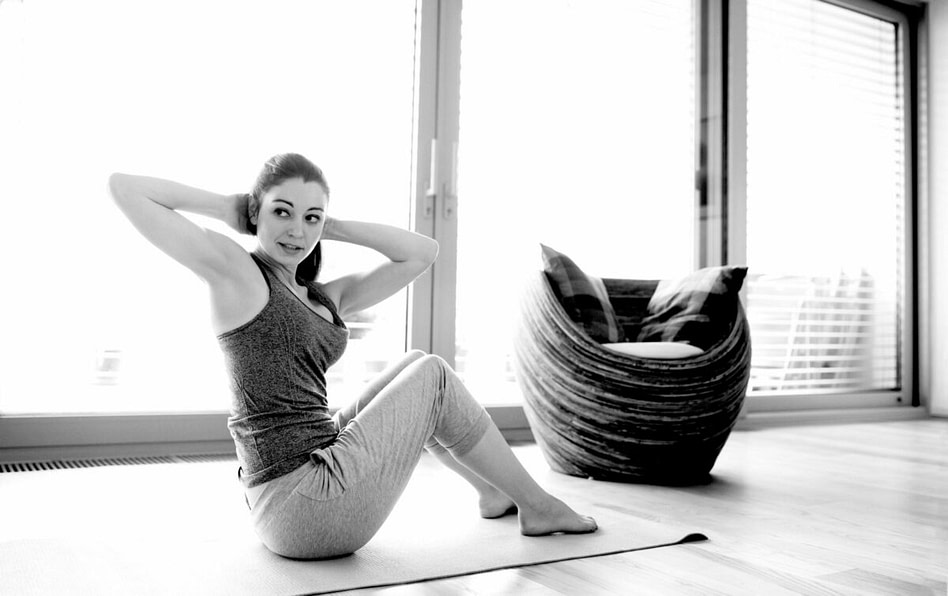 female working on core training in her home