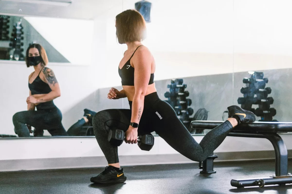 a female runner in a gym, working her legs out