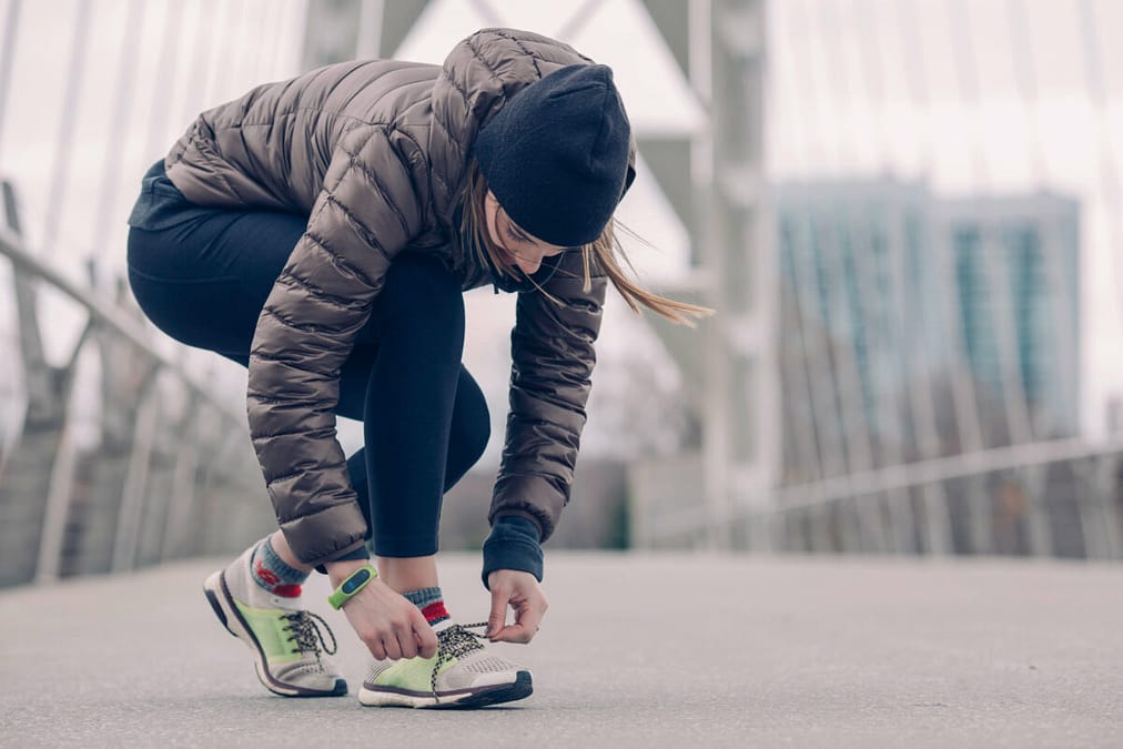 a woman tying her shoelaces