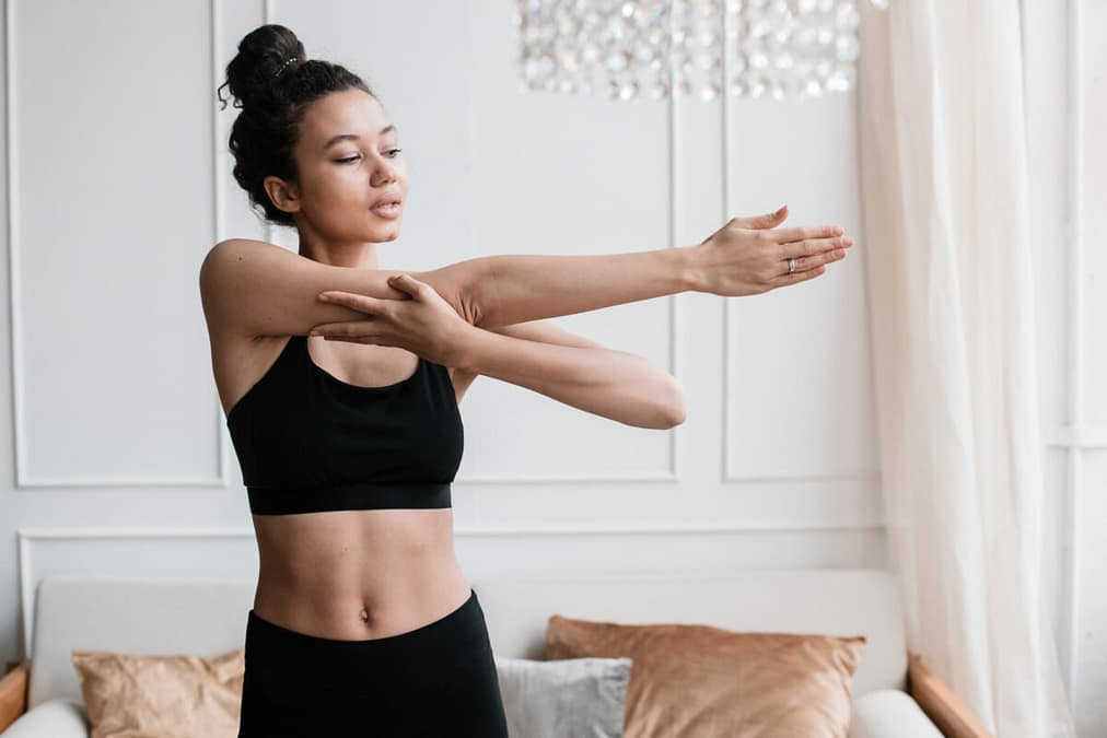Incorporating Stretching into Daily Routine, female stretching morning routine at home