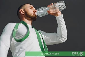 a man drinking from a bottle