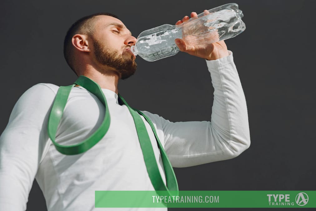 a man drinking from a bottle