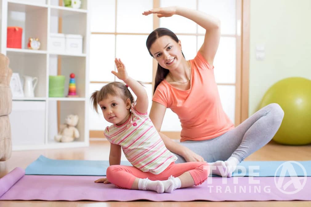 young girl working out with her mom