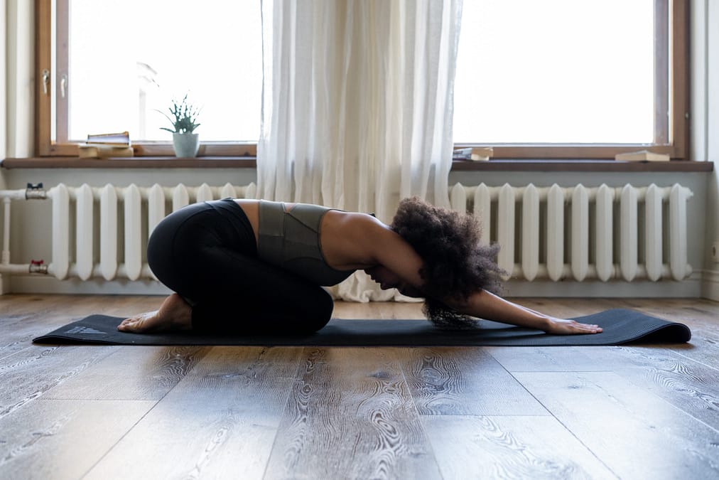 a woman stretching on a mat
