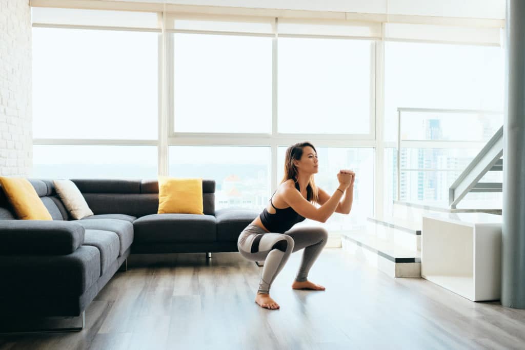 In-home personal trainer guiding a client through a session in a Manhattan home gym