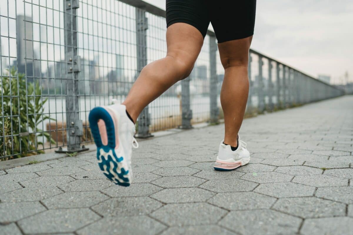 a person's legs and feet in white shoes
