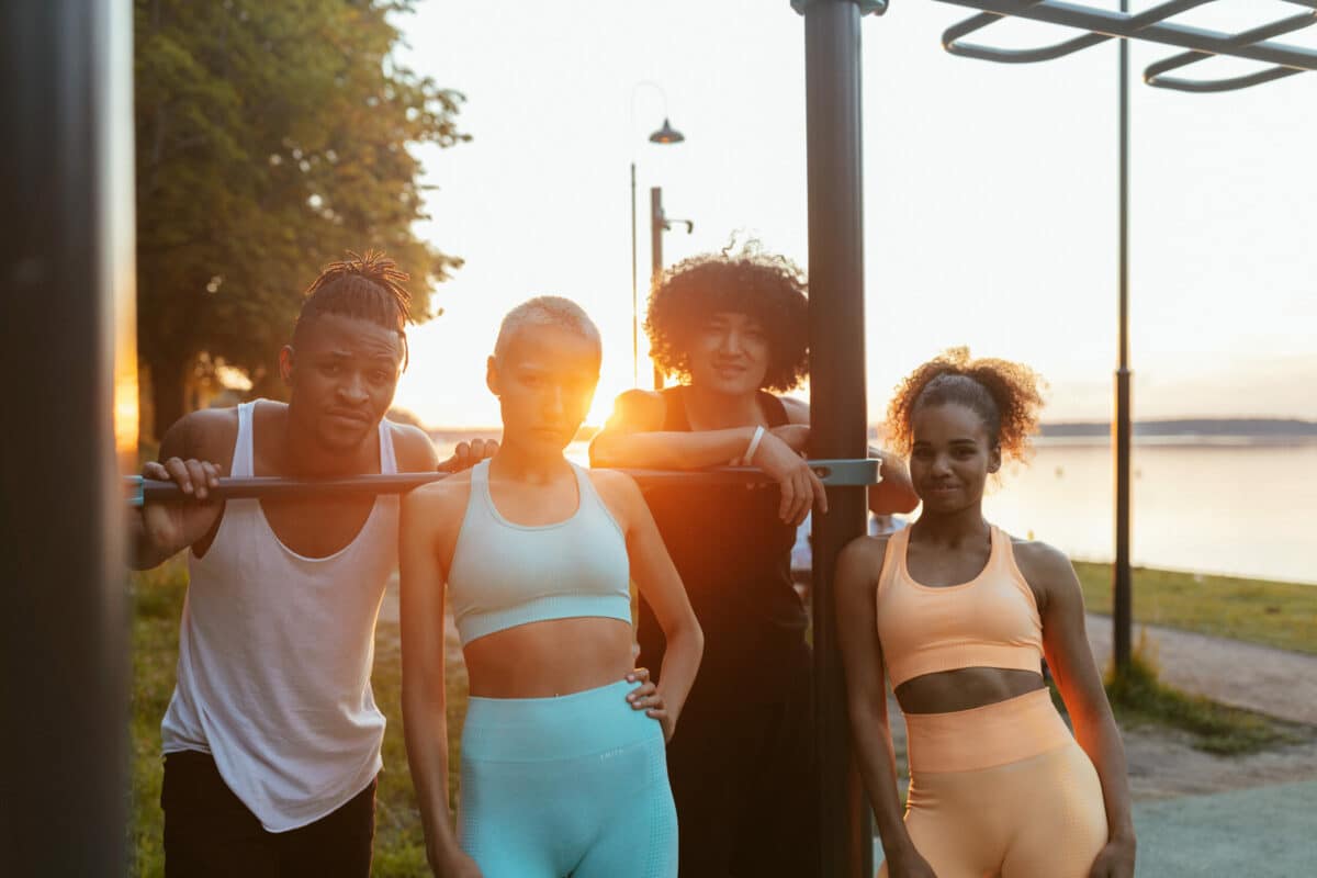 a group of people standing next to a pole