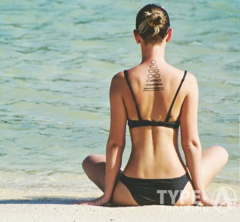 a sexing woman sitting on a beach