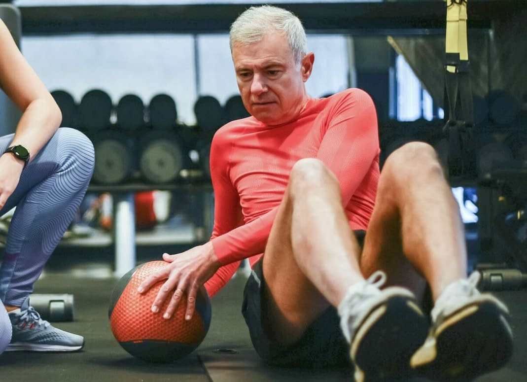 a man in a red shirt with a ball