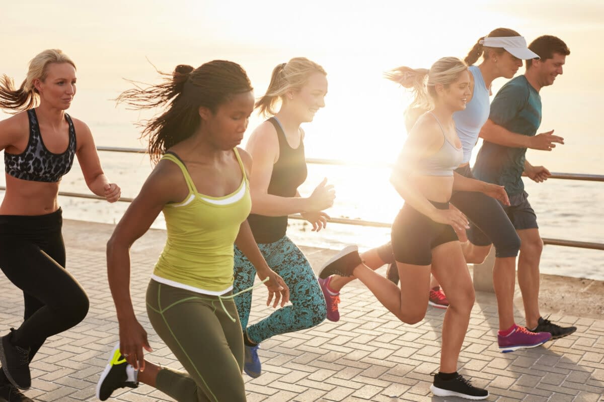 a group of people running on a brick walkway