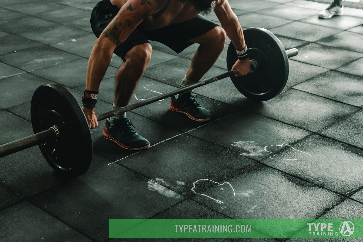 a man lifting weights on a floor