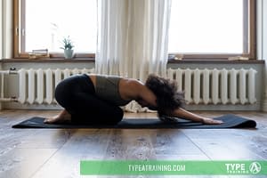 a woman stretching on a mat