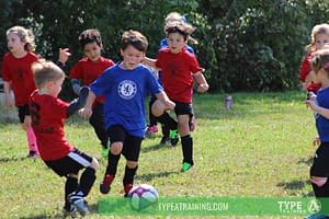 a group of kids playing football