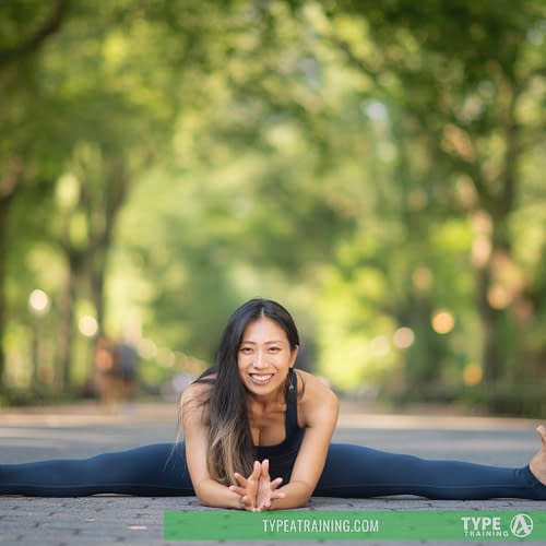 a woman doing a split on a brick path