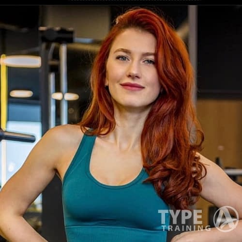 a woman with red hair in a gym