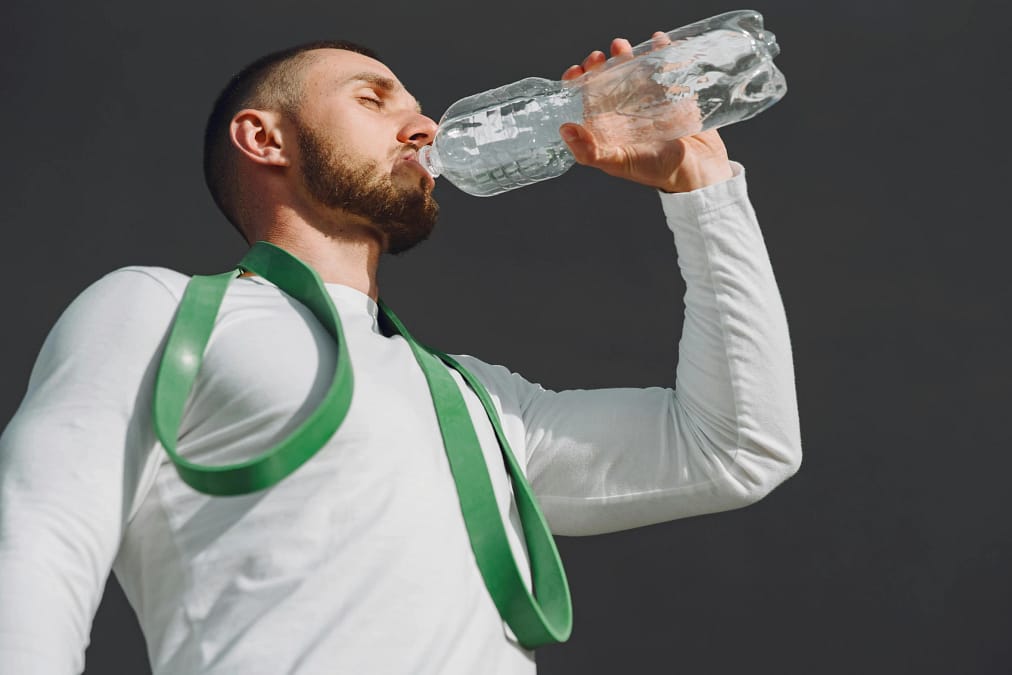 a man drinking from a bottle