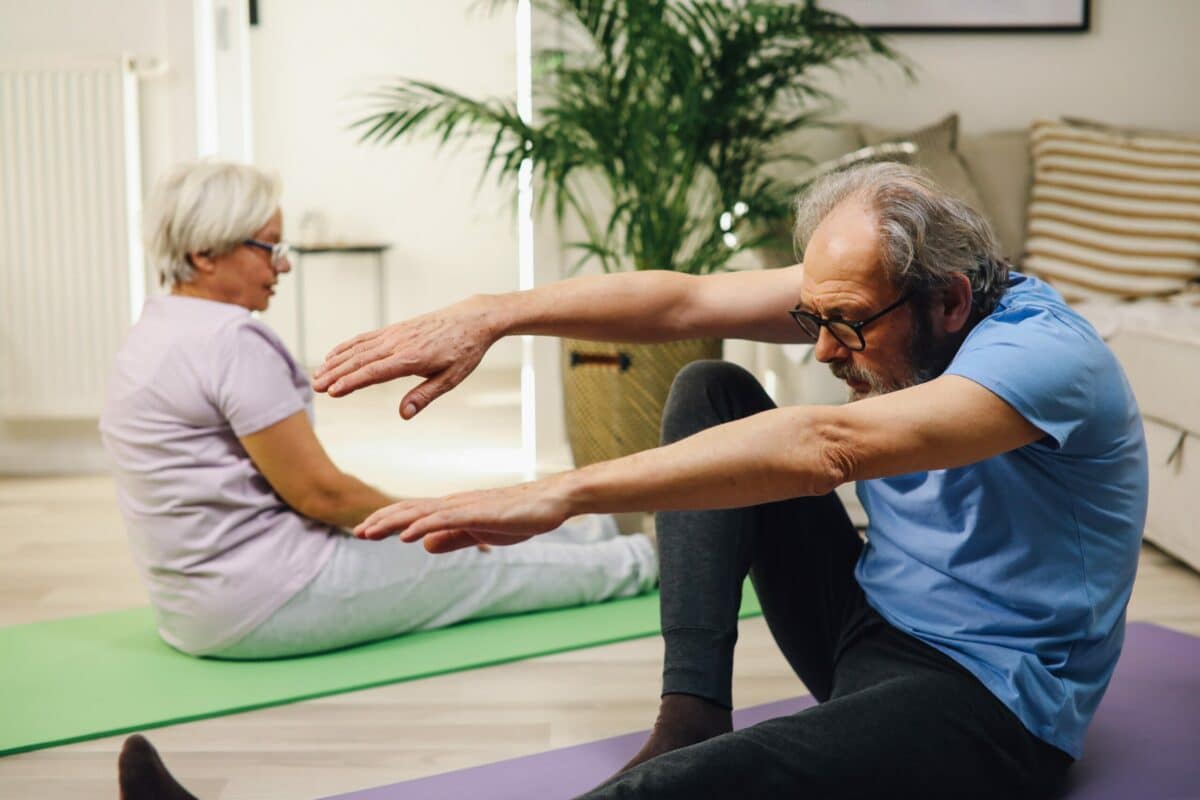 Specific Stretches for Common Problem Areas, older adults sitting stretching on the floor
