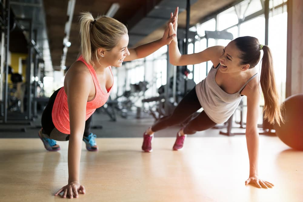 Building an Effective Workout Routine, female couples doing push ups